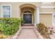 Inviting front entrance with a charming walkway, elegant double doors, and manicured greenery at 2354 Messenger Cir, Safety Harbor, FL 34695