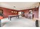 Spacious game room featuring a pool table, pinball machine, bar and carpeted flooring at 2354 Messenger Cir, Safety Harbor, FL 34695
