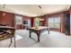 An entertainment room with a pool table, arcade games, a wet bar and multiple windows at 2354 Messenger Cir, Safety Harbor, FL 34695