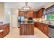 Kitchen featuring granite countertops, an island, stainless steel appliances, and wood cabinets at 2354 Messenger Cir, Safety Harbor, FL 34695