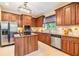 Kitchen featuring stainless appliances, wood cabinets, granite counters, and tile flooring at 2354 Messenger Cir, Safety Harbor, FL 34695