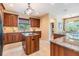 Kitchen featuring a central island, wooden cabinetry, and natural light filtering through the window at 2354 Messenger Cir, Safety Harbor, FL 34695