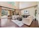 Spacious living room featuring high ceilings, neutral furniture, hardwood floors, and sliding glass doors at 2354 Messenger Cir, Safety Harbor, FL 34695