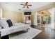 Main bedroom features hardwood floors, ceiling fan, and natural light from sliding doors at 2354 Messenger Cir, Safety Harbor, FL 34695