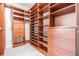 Spacious walk-in closet with custom wood shelving and drawers for ample storage at 2354 Messenger Cir, Safety Harbor, FL 34695