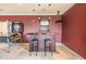 Game room featuring a wet bar with granite counters, pendant lights and adjacent pinball machine at 2354 Messenger Cir, Safety Harbor, FL 34695
