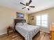 Cozy bedroom with a ceiling fan, natural light, and wood-look flooring at 2597 Countryside Blvd # 210, Clearwater, FL 33761