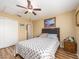 Comfortable bedroom features wood-look floors, ceiling fan, and bright, natural light at 2597 Countryside Blvd # 210, Clearwater, FL 33761