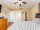 Bedroom view featuring wood-look flooring, ceiling fan, closet and ensuite bathroom at 2597 Countryside Blvd # 210, Clearwater, FL 33761