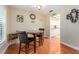 Dining area with a table, two chairs, and open view into kitchen at 2597 Countryside Blvd # 210, Clearwater, FL 33761