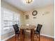 Charming dining area with marble-top table, two chairs, and natural light from window at 2597 Countryside Blvd # 210, Clearwater, FL 33761