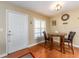 Dining area with a table, two chairs, and entry door at 2597 Countryside Blvd # 210, Clearwater, FL 33761