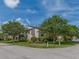 Inviting condo exterior featuring lush landscaping, mature trees, and ample parking at 2597 Countryside Blvd # 210, Clearwater, FL 33761