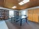 Bright game room featuring ping pong tables, bookshelves, and a storage cabinet under skylights at 2597 Countryside Blvd # 210, Clearwater, FL 33761