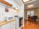 Efficient kitchen featuring white cabinets, a white microwave, and a vintage electric range at 2597 Countryside Blvd # 210, Clearwater, FL 33761