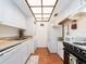 Efficient kitchen features white cabinets, laminate countertop, and modern appliances at 2597 Countryside Blvd # 210, Clearwater, FL 33761