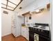 Practical kitchen with white cabinets and modern appliances including a range and refrigerator at 2597 Countryside Blvd # 210, Clearwater, FL 33761