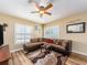 Cozy living room features a plush sectional sofa, decorative rug, and natural light at 2597 Countryside Blvd # 210, Clearwater, FL 33761