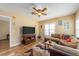 Comfortable living room with a sectional sofa, wood-look floors, and flat-screen TV at 2597 Countryside Blvd # 210, Clearwater, FL 33761