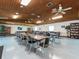 Large meeting room with tables, chairs, ceiling fans, and bookshelves for resident enjoyment at 2597 Countryside Blvd # 210, Clearwater, FL 33761