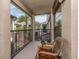 Relaxing screened patio overlooking a courtyard with lush landscaping and mature palm trees at 2597 Countryside Blvd # 210, Clearwater, FL 33761