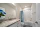 Bright bathroom featuring a granite vanity, mirror, and shower-tub combination at 2816 Grand Kemerton Pl, Tampa, FL 33618
