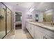 Stylish bathroom showcasing dual sinks, granite countertops, and a glass door shower at 2816 Grand Kemerton Pl, Tampa, FL 33618