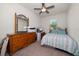 Cozy bedroom with ceiling fan, window, bed, dresser, and computer station at 2816 Grand Kemerton Pl, Tampa, FL 33618