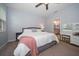 Bright bedroom with a large bed, ceiling fan, and a makeup vanity with lighting at 2816 Grand Kemerton Pl, Tampa, FL 33618