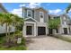 Charming two-story townhome featuring a paver driveway, attached garage, and beautiful landscaping at 2816 Grand Kemerton Pl, Tampa, FL 33618