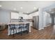 Modern kitchen boasts white cabinets, stainless steel appliances, granite countertops, and bar seating at 2816 Grand Kemerton Pl, Tampa, FL 33618