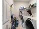 Efficient laundry room with appliances, cleaning supplies and wall storage at 2816 Grand Kemerton Pl, Tampa, FL 33618