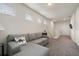 Cozy loft area featuring a comfortable gray sectional sofa and natural light from multiple windows at 2816 Grand Kemerton Pl, Tampa, FL 33618