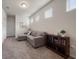 Comfortable loft area furnished with a gray sectional sofa and a wooden bookcase at 2816 Grand Kemerton Pl, Tampa, FL 33618