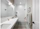 Modern bathroom with double sinks, subway tile, and shower-tub combo, creating a clean and stylish space at 2890 Alexandria Marie Ln, Lutz, FL 33559