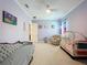 Cozy Bedroom featuring a daybed, recliner, crib, and soothing lilac walls for a peaceful retreat at 2890 Alexandria Marie Ln, Lutz, FL 33559