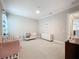 Bright Bedroom with neutral walls, crown molding, and two white cribs, offering a serene space at 2890 Alexandria Marie Ln, Lutz, FL 33559