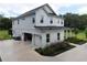 An exterior side view showcases a two-car garage and lush landscaping at 2890 Alexandria Marie Ln, Lutz, FL 33559