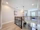 Hallway featuring a modern railing, hardwood floors and natural light at 2890 Alexandria Marie Ln, Lutz, FL 33559