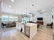 Open concept kitchen features a large island with a dishwasher and pendant lighting at 2890 Alexandria Marie Ln, Lutz, FL 33559