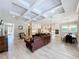 Open concept living area features a coffered ceiling, kitchen with a dining area, and comfortable seating at 2890 Alexandria Marie Ln, Lutz, FL 33559