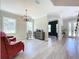 Open-concept living room with hardwood floors, decorative lighting, and access to other living spaces at 2890 Alexandria Marie Ln, Lutz, FL 33559
