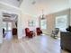 Bright living room featuring hardwood floors, decorative lighting, and access to outdoor living spaces at 2890 Alexandria Marie Ln, Lutz, FL 33559