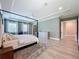 Stylish main bedroom with a four-poster bed, neutral color palette, and an ensuite bathroom at 2890 Alexandria Marie Ln, Lutz, FL 33559