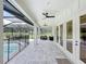Extended covered patio with pool, lounge seating, and ceiling fans for outdoor enjoyment at 2890 Alexandria Marie Ln, Lutz, FL 33559