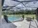 Enjoy the outdoors in this caged pool, complete with patio and table for relaxing and entertaining at 2890 Alexandria Marie Ln, Lutz, FL 33559
