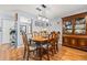 A dining area features hardwood floors, statement lighting, and a hutch for storage at 2919 Fig Ct, Palm Harbor, FL 34684