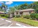 Charming home with mature landscaping and dedicated guest parking, enhancing its curb appeal at 2919 Fig Ct, Palm Harbor, FL 34684