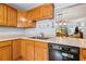 Bright kitchen with wood cabinets, sleek countertops, and a view into the dining area at 2919 Fig Ct, Palm Harbor, FL 34684