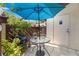 Cozy patio setup with blue umbrella, perfect for outdoor relaxation and enjoying the surrounding greenery at 2919 Fig Ct, Palm Harbor, FL 34684